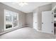 Bright bedroom with a large window, neutral walls, and soft carpet, creating a cozy and serene atmosphere at 8724 Ten Ten Rd, Raleigh, NC 27603