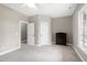 Inviting bedroom with neutral walls, carpet, and white trim; a dark wood dresser adds contrast at 8724 Ten Ten Rd, Raleigh, NC 27603