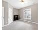 Cozy bedroom featuring neutral carpet, a window offering views, and classic black wood dresser at 8724 Ten Ten Rd, Raleigh, NC 27603