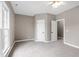 Spacious bedroom with soft carpet, neutral paint, and a large window providing natural light into the room at 8724 Ten Ten Rd, Raleigh, NC 27603
