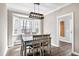 Dining room featuring a dining table, chair and bay window for natural light at 8724 Ten Ten Rd, Raleigh, NC 27603