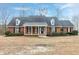 Charming brick home features a well-manicured lawn and welcoming front porch with columns at 8724 Ten Ten Rd, Raleigh, NC 27603