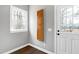 Hallway area with a window and white door at 8724 Ten Ten Rd, Raleigh, NC 27603