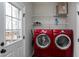 Laundry room with red washer and dryer at 8724 Ten Ten Rd, Raleigh, NC 27603