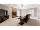 Inviting living room featuring a brick fireplace, plush carpet, and ample space at 8724 Ten Ten Rd, Raleigh, NC 27603