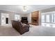 Spacious living room with brick fireplace, plush carpeting, and neutral paint at 8724 Ten Ten Rd, Raleigh, NC 27603