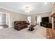 Cozy living room with brick fireplace, comfortable seating, and neutral tones at 8724 Ten Ten Rd, Raleigh, NC 27603