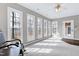 Bright sunroom featuring many windows with a rocking chair at 8724 Ten Ten Rd, Raleigh, NC 27603