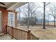 A serene view from the porch, showcasing a peaceful outdoor setting with mature trees at 8724 Ten Ten Rd, Raleigh, NC 27603