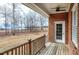 A welcoming outdoor space featuring a ceiling fan and a clear view of the surrounding natural landscape at 8724 Ten Ten Rd, Raleigh, NC 27603