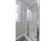 Bathroom showcasing a glass enclosed shower and a window bringing natural light into the space at 8724 Ten Ten Rd, Raleigh, NC 27603