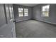 Bedroom featuring neutral walls and carpet plus multiple large windows at 912 Hillsboro St, Oxford, NC 27565