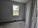 Empty bedroom with carpet and a window overlooking the front yard at 912 Hillsboro St, Oxford, NC 27565