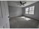 Spacious bedroom with carpet, two large windows and neutral paint at 912 Hillsboro St, Oxford, NC 27565