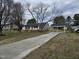 Charming one story home with a blue front door, gray siding and a long drive at 912 Hillsboro St, Oxford, NC 27565