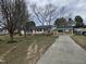 Charming one story home with a blue front door, gray siding and a long drive at 912 Hillsboro St, Oxford, NC 27565