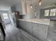 Open concept kitchen featuring gray cabinets, light countertops and wood floors at 912 Hillsboro St, Oxford, NC 27565