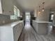 Open concept kitchen featuring white cabinets, light countertops and wood floors at 912 Hillsboro St, Oxford, NC 27565