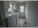 Bright laundry room with modern appliances and a door leading to the outside at 912 Hillsboro St, Oxford, NC 27565