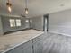 Open-concept living room featuring modern lighting, neutral colors, and updated flooring at 912 Hillsboro St, Oxford, NC 27565