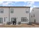 Back of home with a sliding glass doors that lead to a cozy backyard patio space at 94 Paperwhite Pl, Clayton, NC 27527