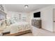 Cozy bedroom with a large bed, a dresser with a TV, and natural light from a window at 94 Paperwhite Pl, Clayton, NC 27527