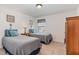 Cozy bedroom featuring two twin beds with coordinated bedding and natural light at 94 Paperwhite Pl, Clayton, NC 27527