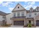 Charming two-story home featuring brick accents, a two-car garage, and tidy landscaping at 94 Paperwhite Pl, Clayton, NC 27527