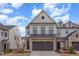 Beautiful two-story townhome with a brick garage, situated on a quiet street under a partly cloudy sky at 94 Paperwhite Pl, Clayton, NC 27527