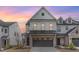 Beautiful two-story home with brick and siding exterior, a two-car garage, and a well-manicured lawn at 94 Paperwhite Pl, Clayton, NC 27527