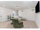 Bright living room with comfortable seating, neutral walls, and contemporary lighting at 94 Paperwhite Pl, Clayton, NC 27527