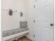 Convenient mud room with a built-in bench, hooks for coats, and a door to the exterior at 94 Paperwhite Pl, Clayton, NC 27527