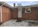 A back entrance with a white door and brick facade, plus a small window at 1006 Linwood Ave, Durham, NC 27701
