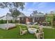 A cozy backyard with Adirondack chairs surrounding a fire pit, plus a hot tub and dining area at 1006 Linwood Ave, Durham, NC 27701