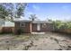 The backyard features a classic brick exterior with a small gravel section and fenced perimeter at 1006 Linwood Ave, Durham, NC 27701