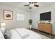 Comfortable bedroom with ceiling fan, ample natural light, and a modern entertainment center at 1006 Linwood Ave, Durham, NC 27701
