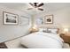 Bright bedroom with neutral tones, two windows, and ceiling fan with art accents at 1006 Linwood Ave, Durham, NC 27701