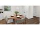 Bright dining area features a wood table set for four, complemented by hardwood flooring and white trim at 1006 Linwood Ave, Durham, NC 27701