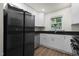 Modern kitchen features stainless steel appliances, white cabinets, and granite countertops at 1006 Linwood Ave, Durham, NC 27701