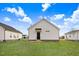 View of backyard featuring an exterior view of a white home and lush green lawn at 1021 E Edgerton St, Dunn, NC 28334