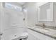 Well lit bathroom with a shower-tub combo and granite counters at 1021 E Edgerton St, Dunn, NC 28334