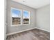 This bedroom has grey walls, wood floors and natural light through the windows at 1021 E Edgerton St, Dunn, NC 28334