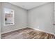 Bedroom with a window, wood floors, and a door leading to another room at 1021 E Edgerton St, Dunn, NC 28334