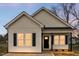 Charming single story home with black shutters, white siding and a cozy front porch at 1021 E Edgerton St, Dunn, NC 28334