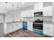 Modern kitchen featuring white cabinets, granite countertops, and stainless steel appliances at 1021 E Edgerton St, Dunn, NC 28334