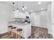 Well-lit kitchen with modern appliances, a breakfast bar, and stylish pendant lighting at 1021 E Edgerton St, Dunn, NC 28334