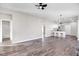 Open layout with hardwood floors, ceiling fan, leading to the kitchen and bathroom at 1021 E Edgerton St, Dunn, NC 28334