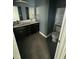 Stylish bathroom features double sinks, dark cabinets, modern fixtures, and tiled floor at 104 Ginger Cir, Selma, NC 27576