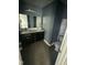 Modern bathroom features double sinks, dark cabinets, and tiled floor at 104 Ginger Cir, Selma, NC 27576
