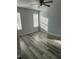 Bright bedroom has new vinyl flooring, light gray walls, ceiling fan, and multiple windows at 104 Ginger Cir, Selma, NC 27576